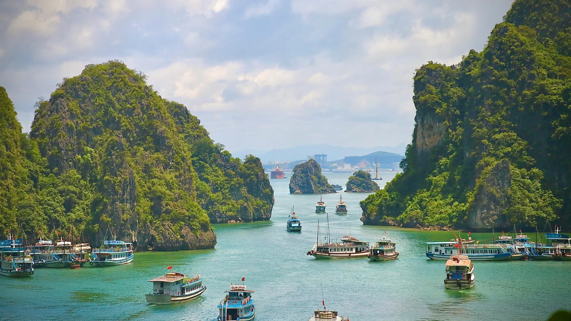 Limestone karsts and a junk boat, Halong Bay, Vietnam